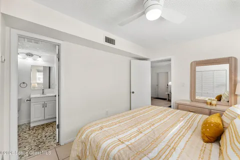 a bedroom with a bed a dresser and window