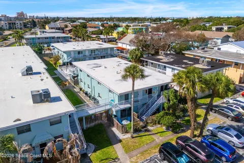 an aerial view of a house with garden space and lake view