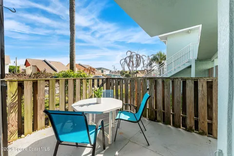 a view of a chair and table in the balcony