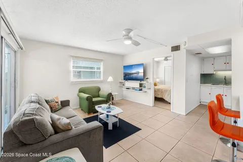 a living room with furniture and kitchen view