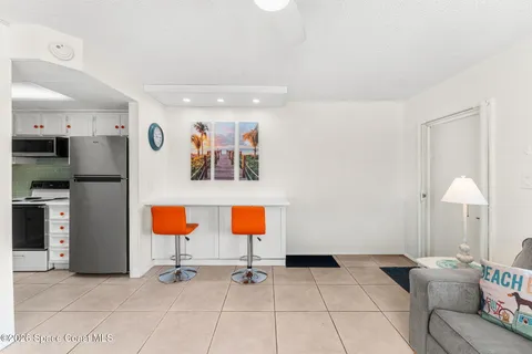 a kitchen with stainless steel appliances a refrigerator sink and white cabinets