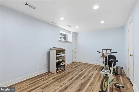 a view of workspace filled with furniture and wooden floor