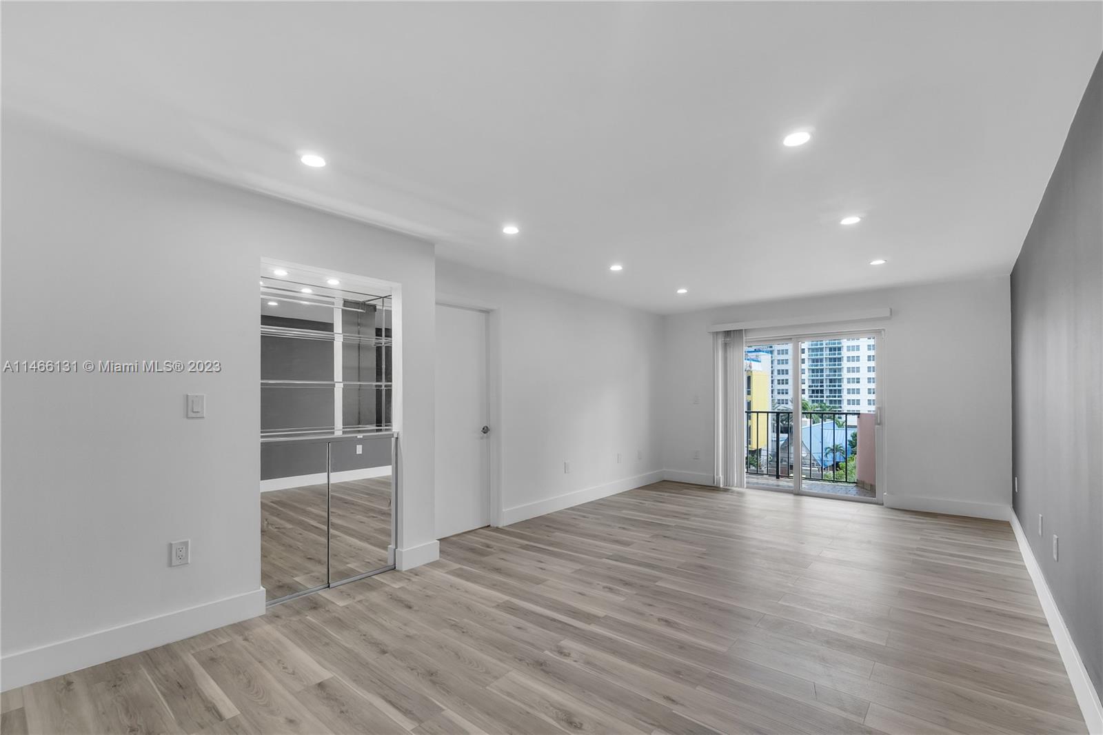 6920 Harding Avenue, Unit 502 Miami Beach, FL 33141 - Photo 24 of 39 an empty room with wooden floor and windows