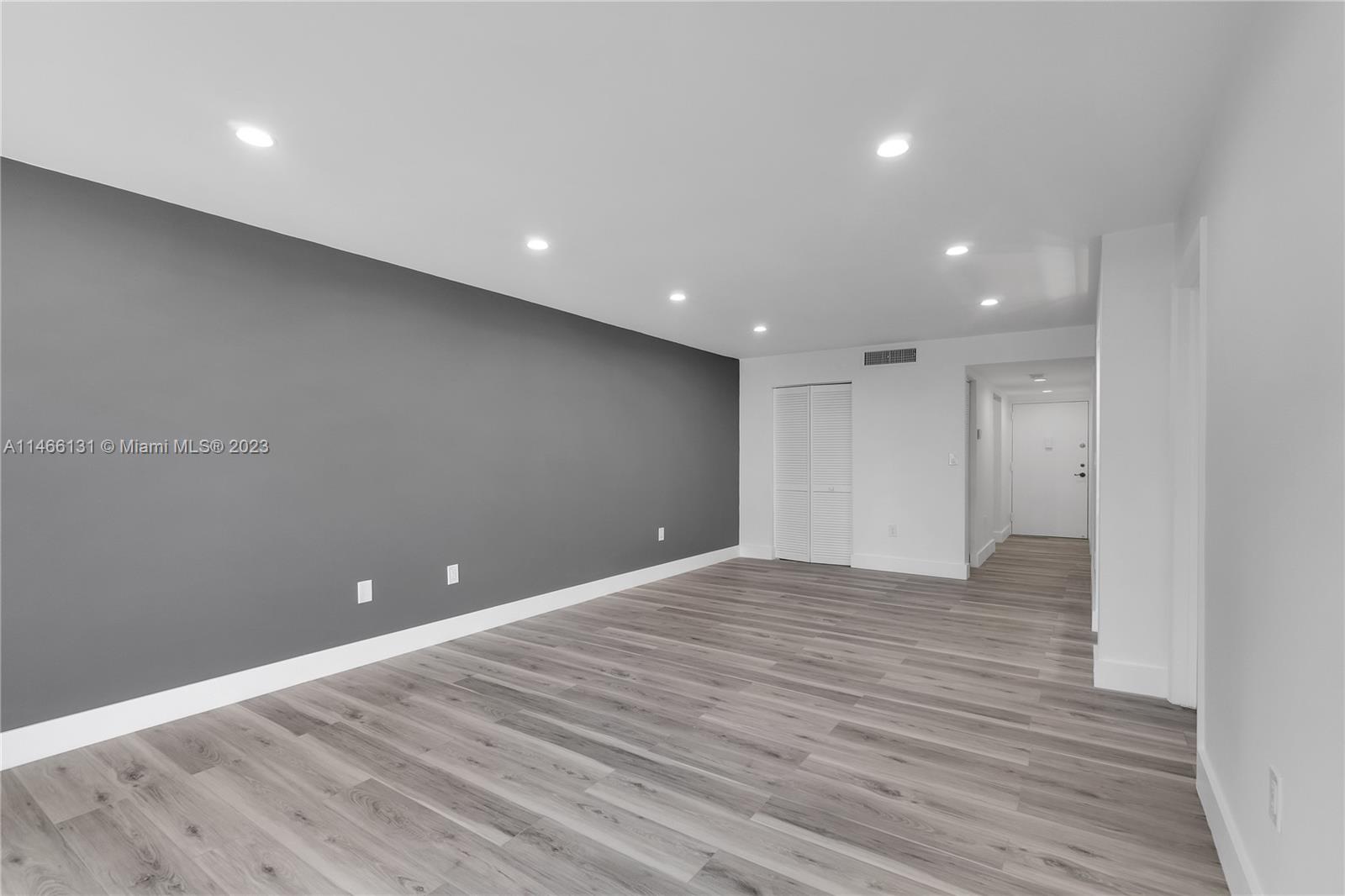 6920 Harding Avenue, Unit 502 Miami Beach, FL 33141 - Photo 26 of 39 a view of an empty room with wooden floor and entryway
