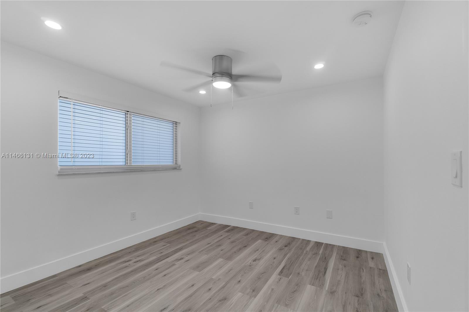 6920 Harding Avenue, Unit 502 Miami Beach, FL 33141 - Photo 27 of 39 wooden floor in an empty room with a window