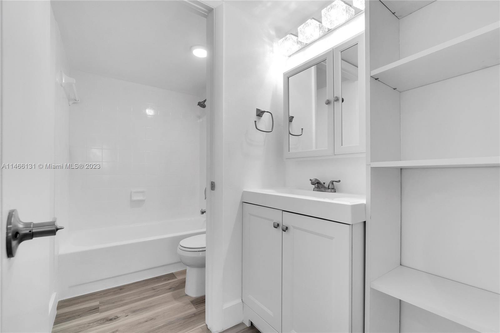 6920 Harding Avenue, Unit 502 Miami Beach, FL 33141 - Photo 34 of 39 a bathroom with a bathtub shower sink vanity and toilet
