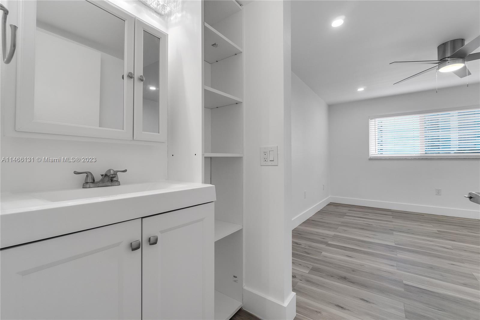 6920 Harding Avenue, Unit 502 Miami Beach, FL 33141 - Photo 36 of 39 a bathroom with a sink and mirror