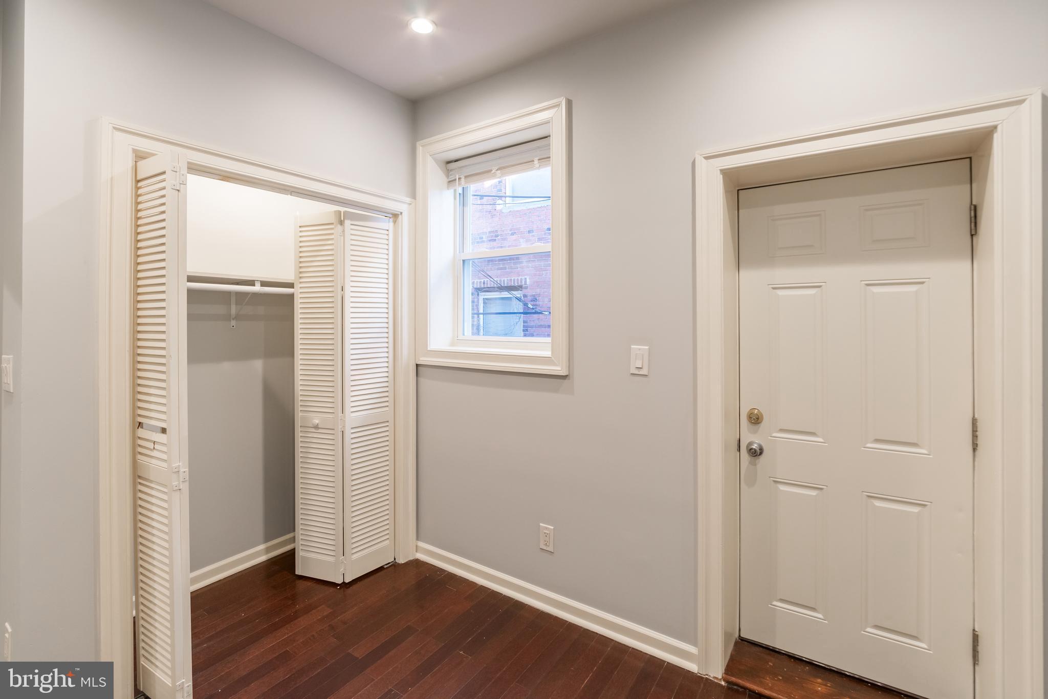 723 South 56th Street, Unit 1 Philadelphia, PA 19143 - Photo 14 of 18 an empty room with wooden floor and a window