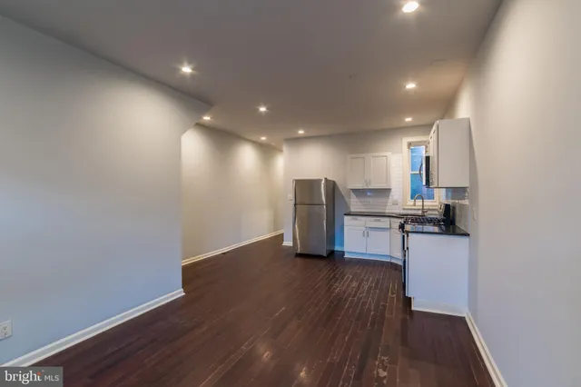 a view of kitchen with wooden floor and electronic appliances