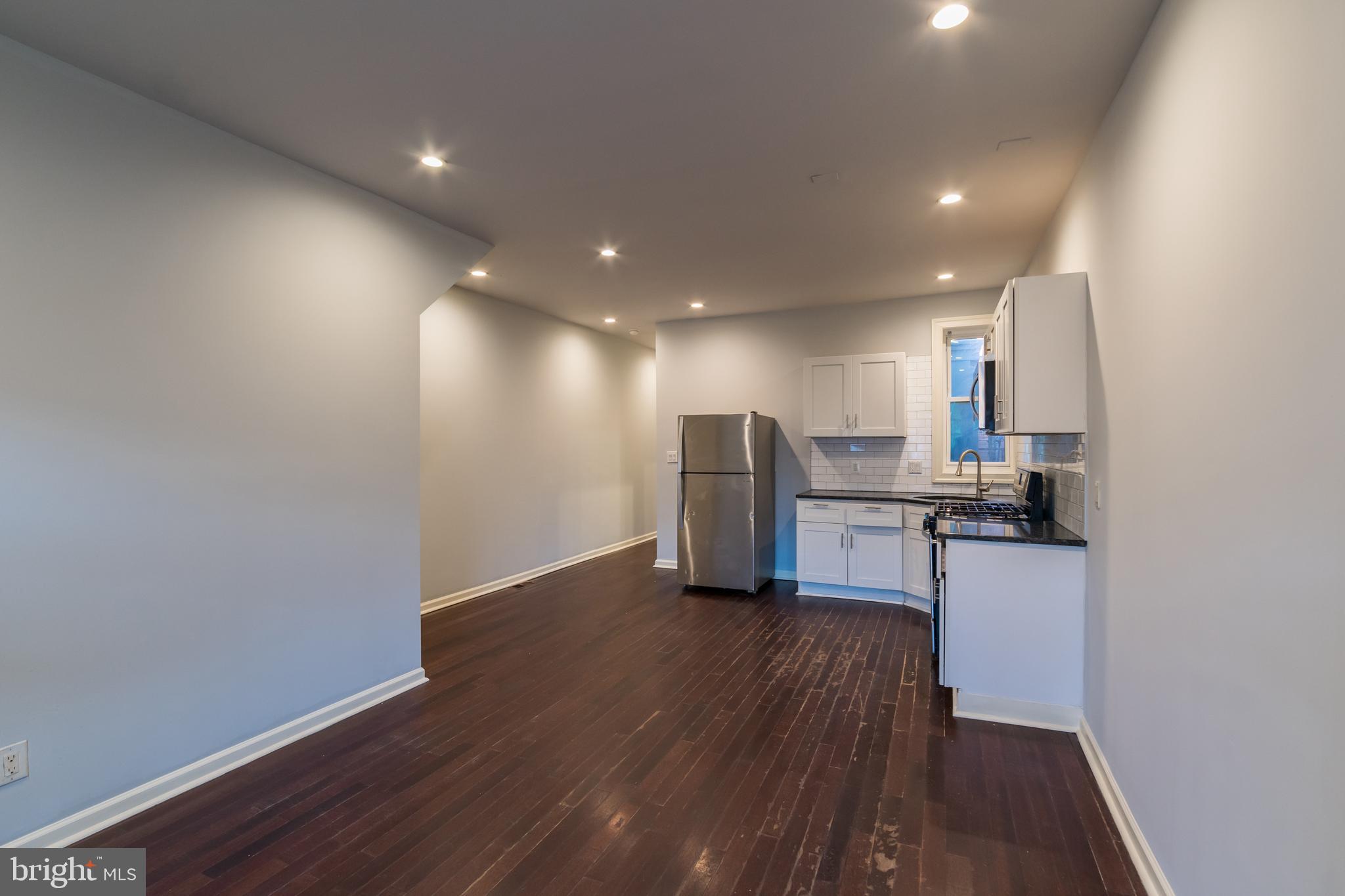 723 South 56th Street, Unit 1 Philadelphia, PA 19143 - Photo 2 of 18 a view of kitchen with wooden floor and electronic appliances