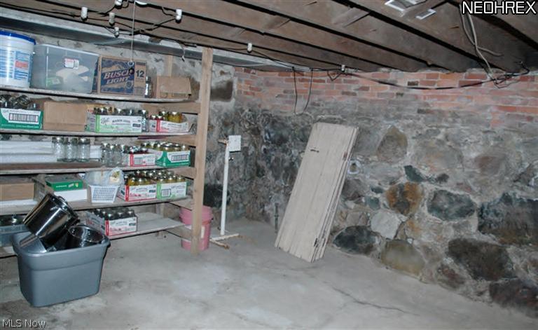 8481 Vandemark Road Lodi, OH 44254 - Photo 25 of 25 Useable basement with original stone foundation offers a huge fruit cellar, glass block windows installed too.