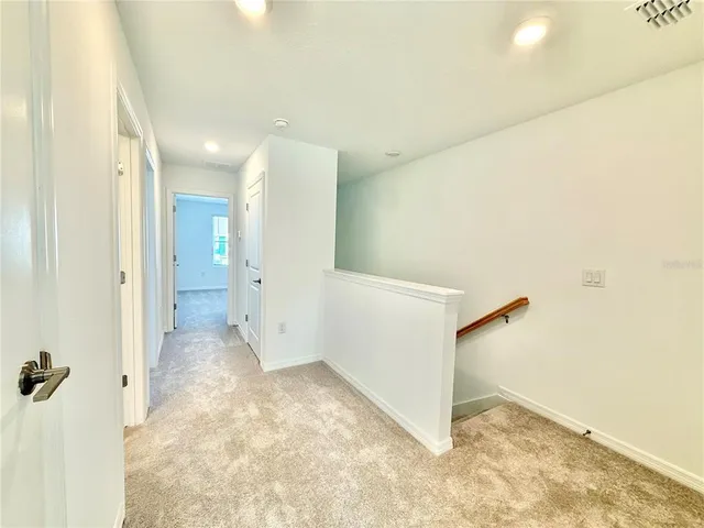 a view of a hallway with a bathroom