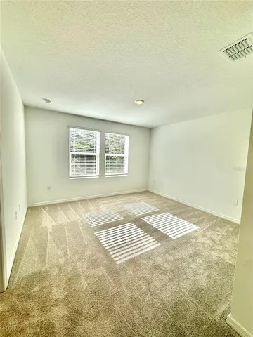a view of an empty room and a window