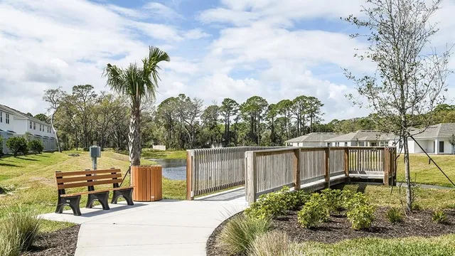 swimming pool with large trees and a wooden fence