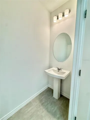 a bathroom with a sink a toilet and mirror