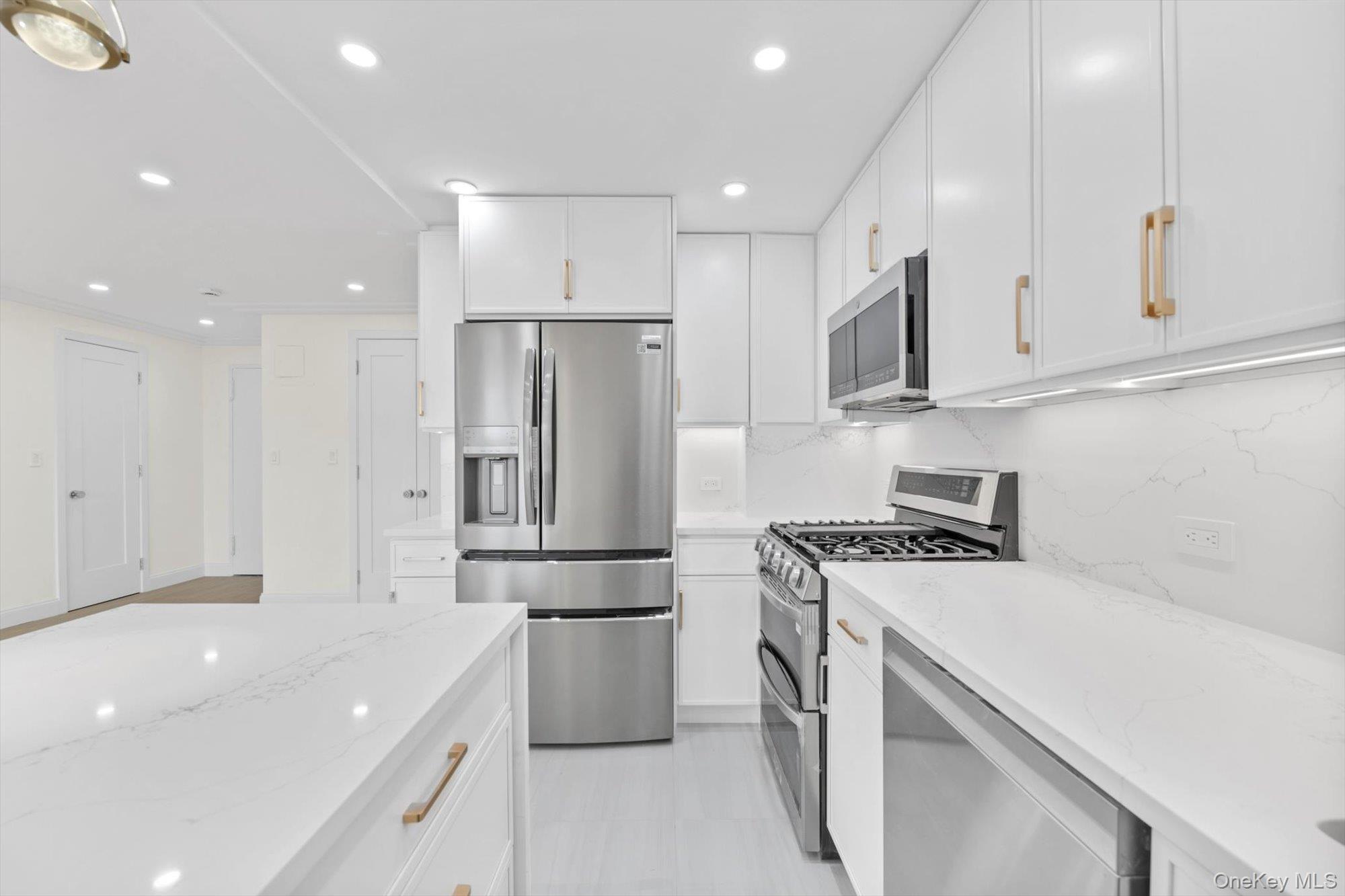 555 Kappock Street, Unit 12G Bronx, NY 10463 - Photo 3 of 19 a kitchen with stainless steel appliances a refrigerator sink and white cabinets