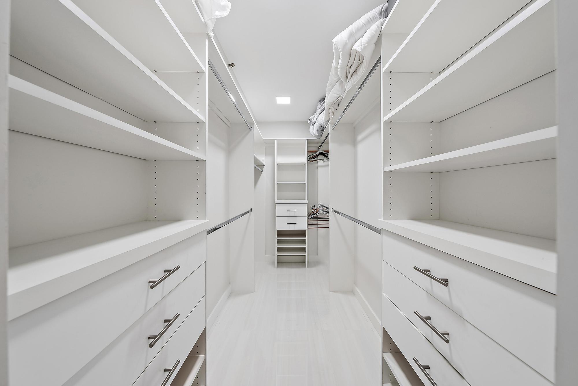 5070 North Ocean Drive, Unit 5B Riviera Beach, FL 33404 - Photo 11 of 37 a view of walk in closet with empty racks