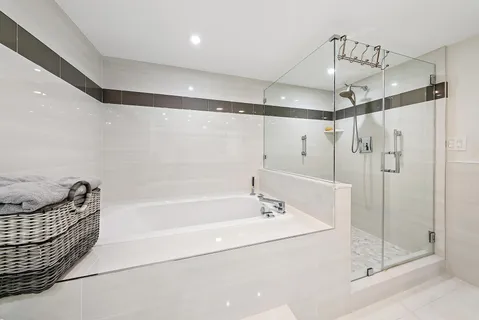 a bathroom with a bathtub a shower and a sink