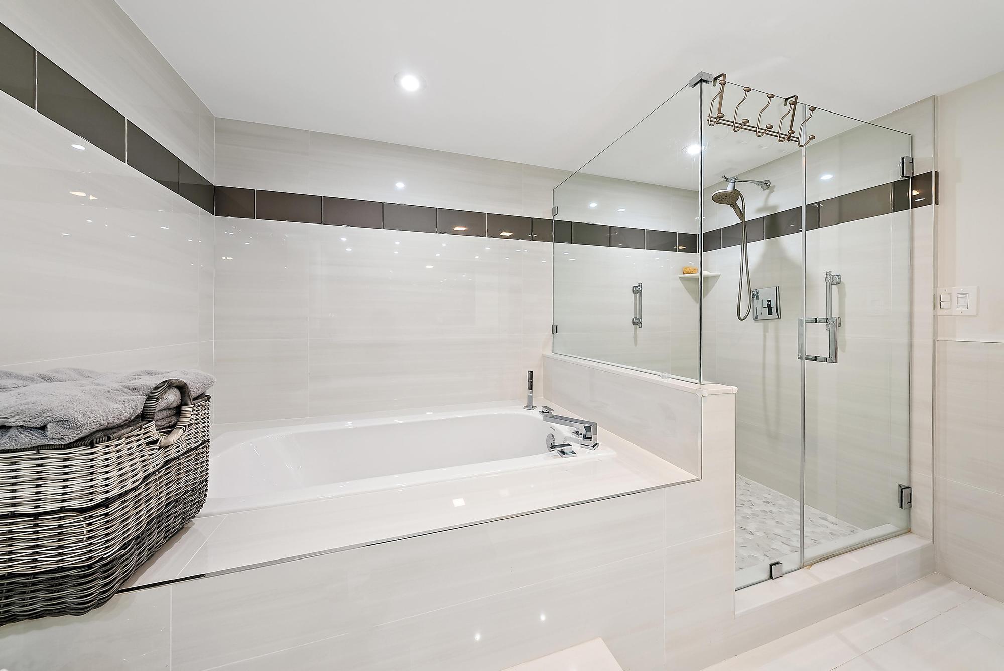 5070 North Ocean Drive, Unit 5B Riviera Beach, FL 33404 - Photo 13 of 37 a bathroom with a bathtub a shower and a sink