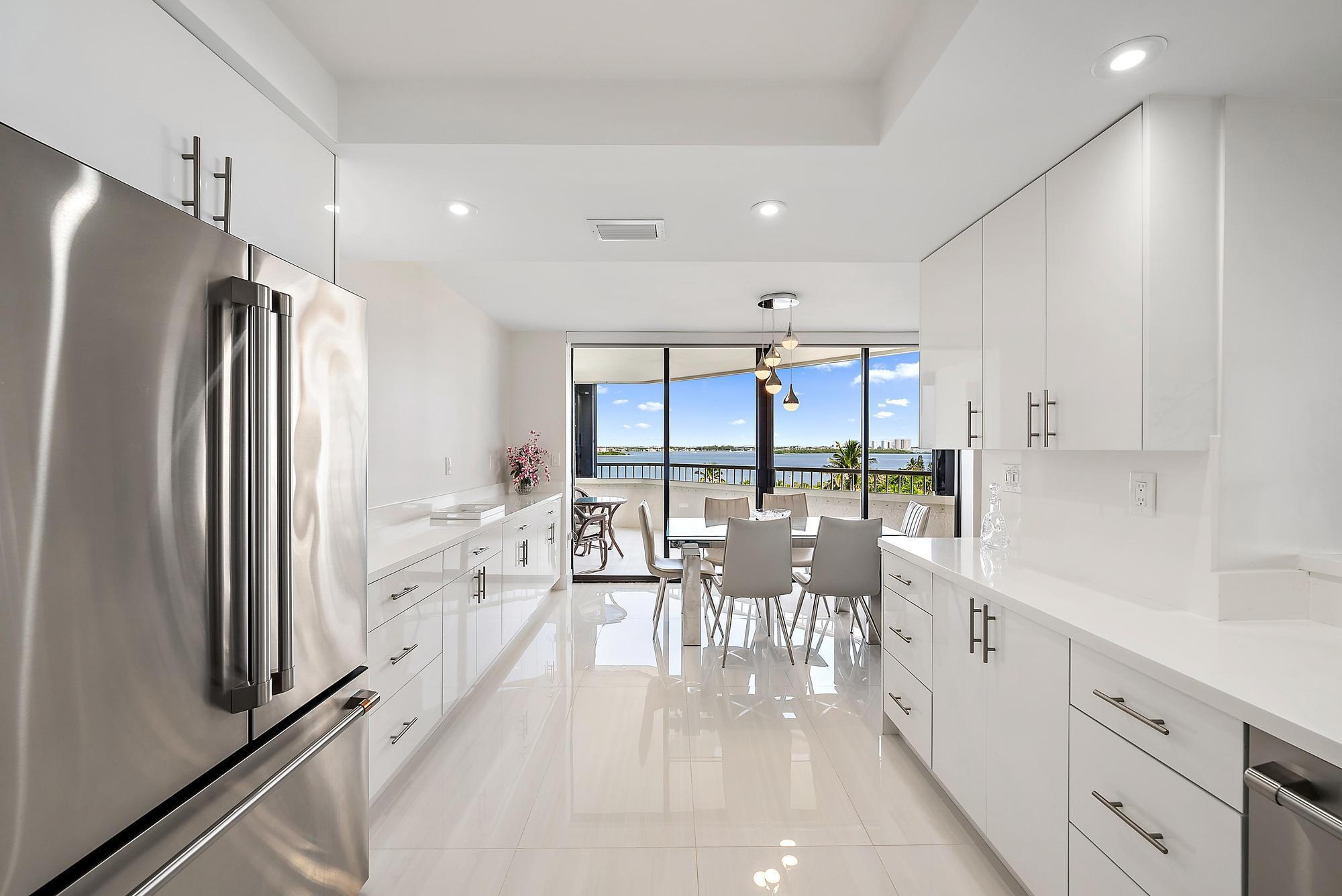 5070 North Ocean Drive, Unit 5B Riviera Beach, FL 33404 - Photo 16 of 37 a large kitchen with a large window and stainless steel appliances