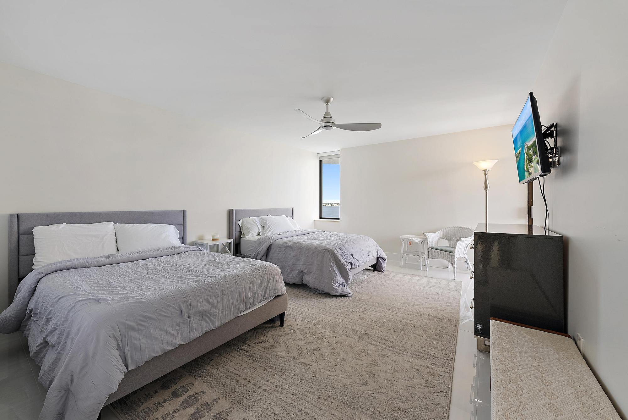 5070 North Ocean Drive, Unit 5B Riviera Beach, FL 33404 - Photo 20 of 37 a bedroom with bed and a potted plant
