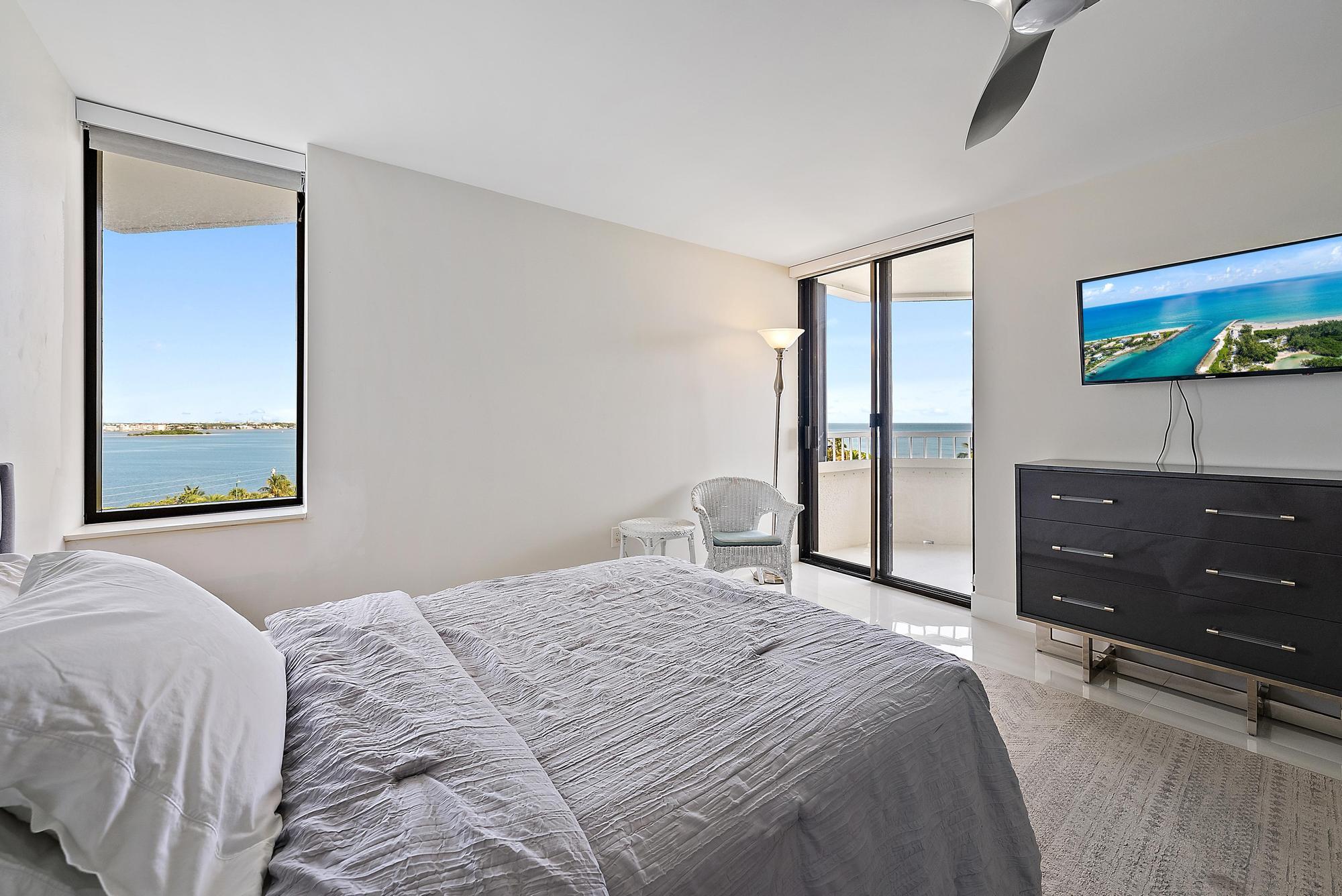 5070 North Ocean Drive, Unit 5B Riviera Beach, FL 33404 - Photo 21 of 37 a bedroom with a bed and a dresser