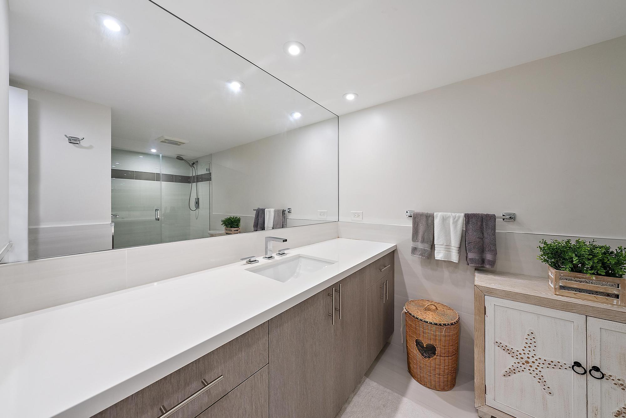 5070 North Ocean Drive, Unit 5B Riviera Beach, FL 33404 - Photo 22 of 37 a bathroom with a sink double vanity and a mirror