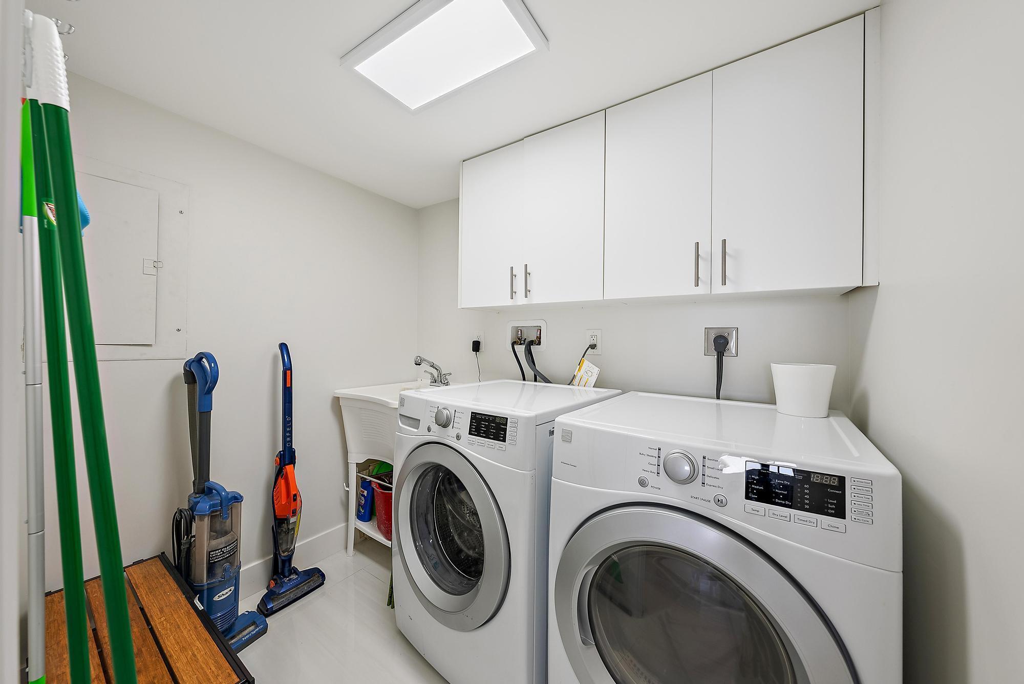 5070 North Ocean Drive, Unit 5B Riviera Beach, FL 33404 - Photo 23 of 37 a view of storage and utility room with washer and dryer
