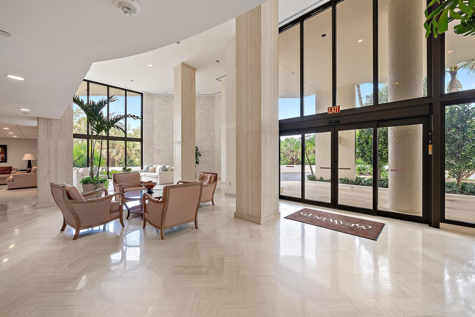 5070 North Ocean Drive, Unit 5B Riviera Beach, FL 33404 - Photo 24 of 37 a living room with furniture and large windows