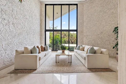 a living room with furniture and a book shelf