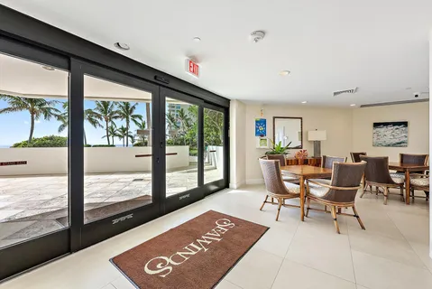 a kitchen with stainless steel appliances kitchen island granite countertop a table and chairs in it