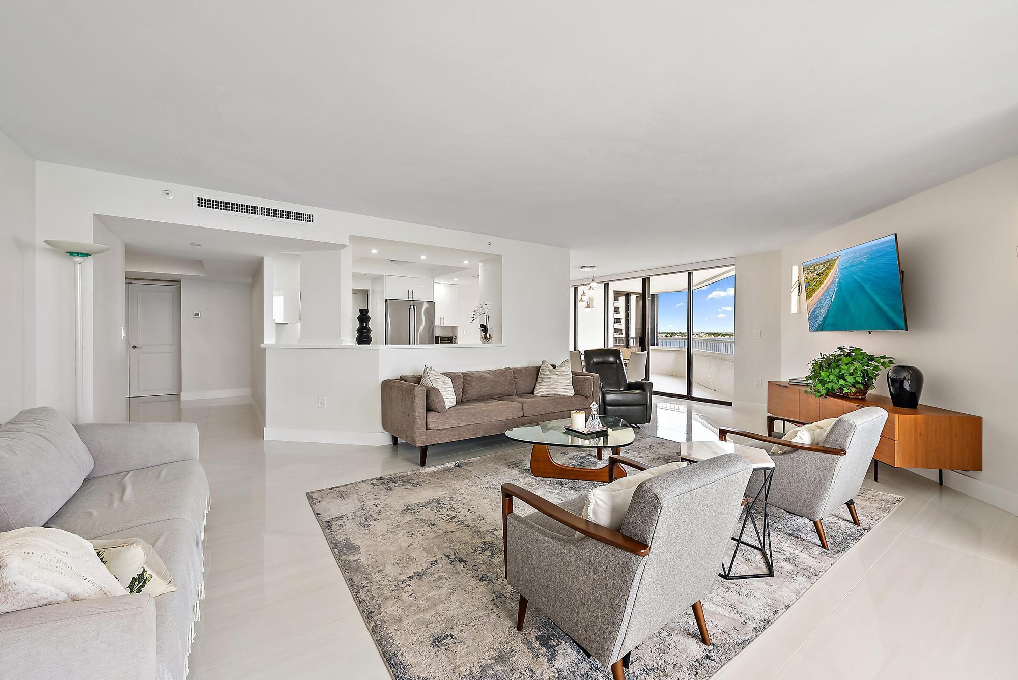5070 North Ocean Drive, Unit 5B Riviera Beach, FL 33404 - Photo 5 of 37 a living room with furniture and a large window