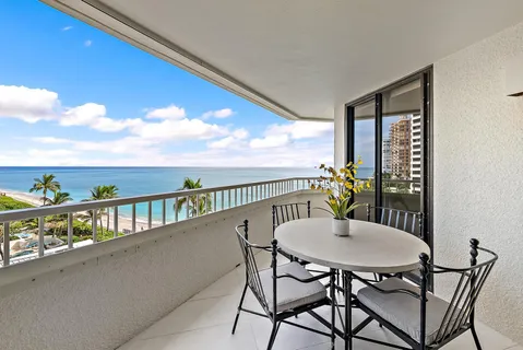 a view of a balcony with a table and chairs