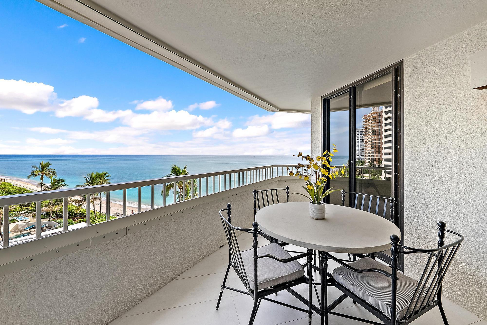 5070 North Ocean Drive, Unit 5B Riviera Beach, FL 33404 - Photo 8 of 37 a view of a balcony with a table and chairs