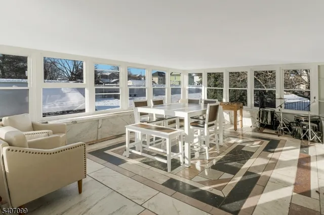 a living room with furniture a fireplace and a floor to ceiling window