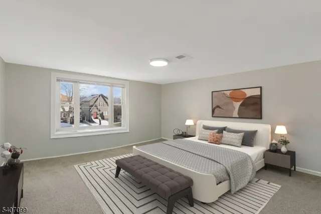 a bedroom with a bed and a painting on the wall