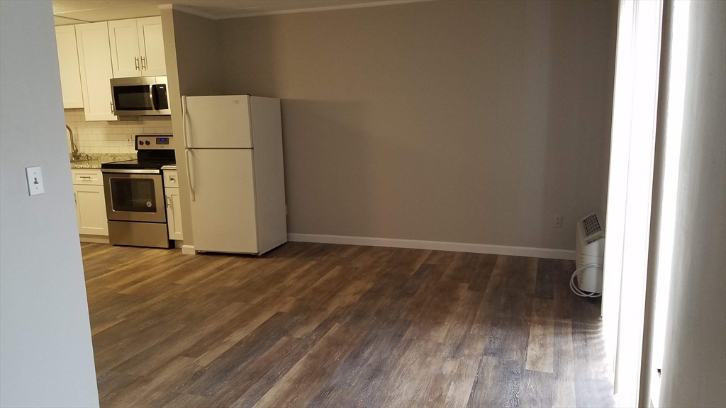 40 Cochituate Road, Unit 40 Framingham, MA 01701 - Photo 11 of 12 a view of a kitchen with a refrigerator a microwave and a window