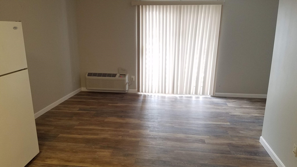 40 Cochituate Road, Unit 40 Framingham, MA 01701 - Photo 8 of 12 a view of a room with wooden floor and a window