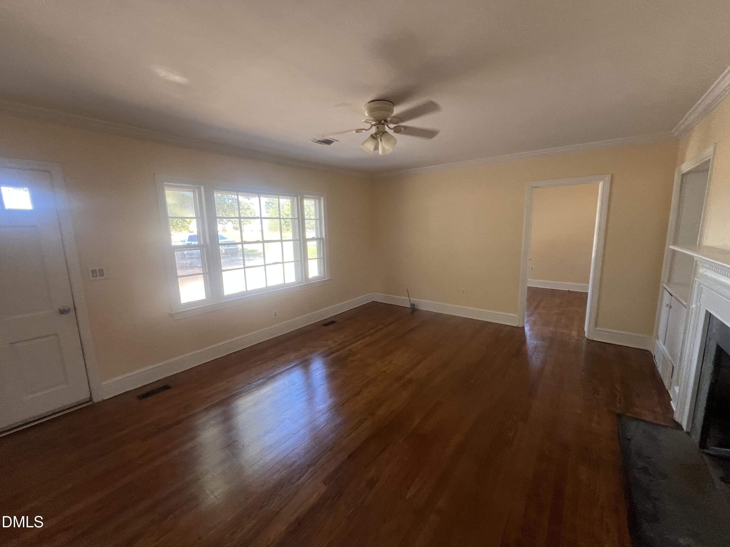 122 Bill Avery Road Coats, NC 27521 - Photo 11 of 51 a view of an empty room with wooden floor and a window