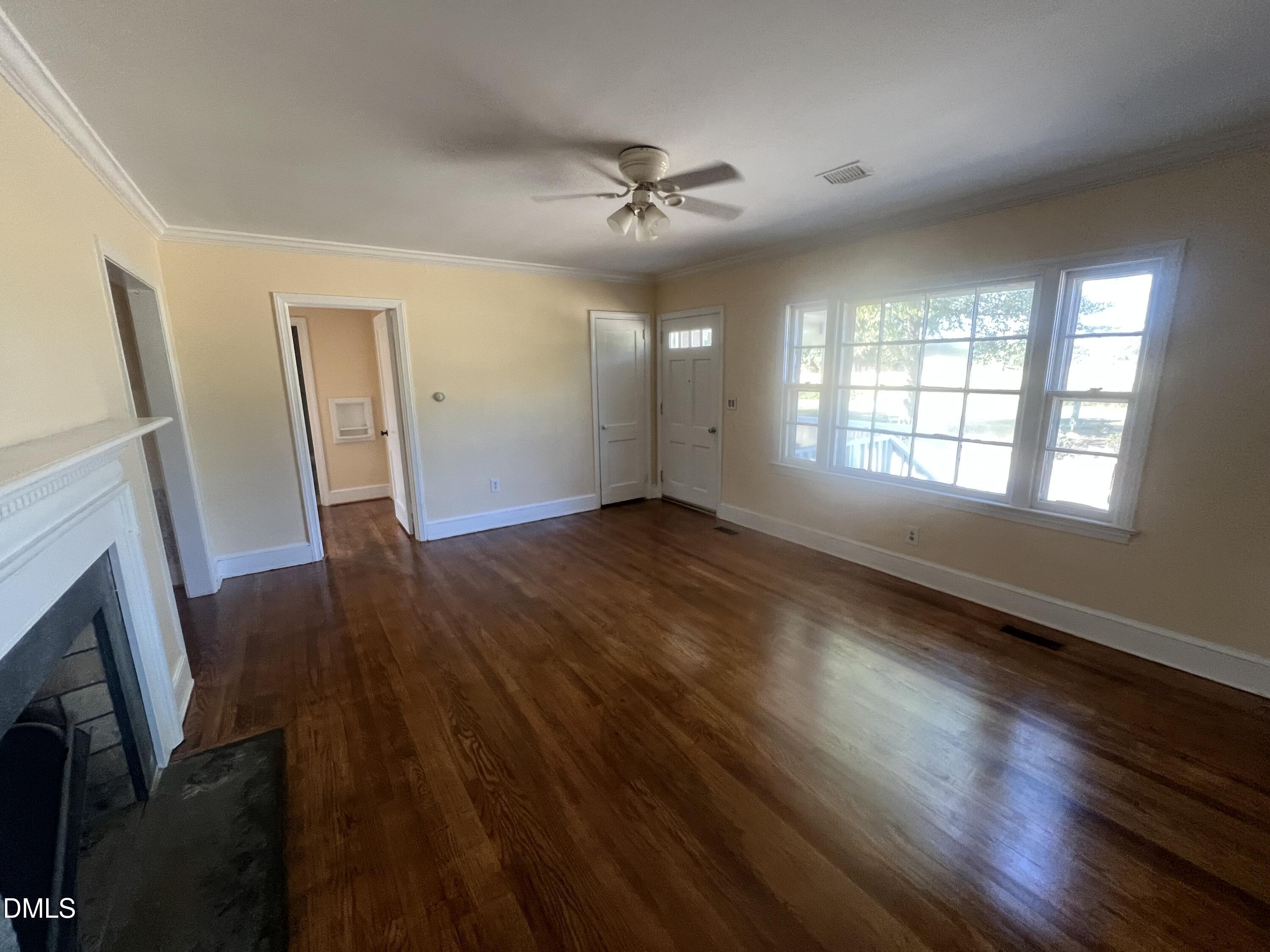 122 Bill Avery Road Coats, NC 27521 - Photo 12 of 51 wooden floor in an empty room with a fireplace