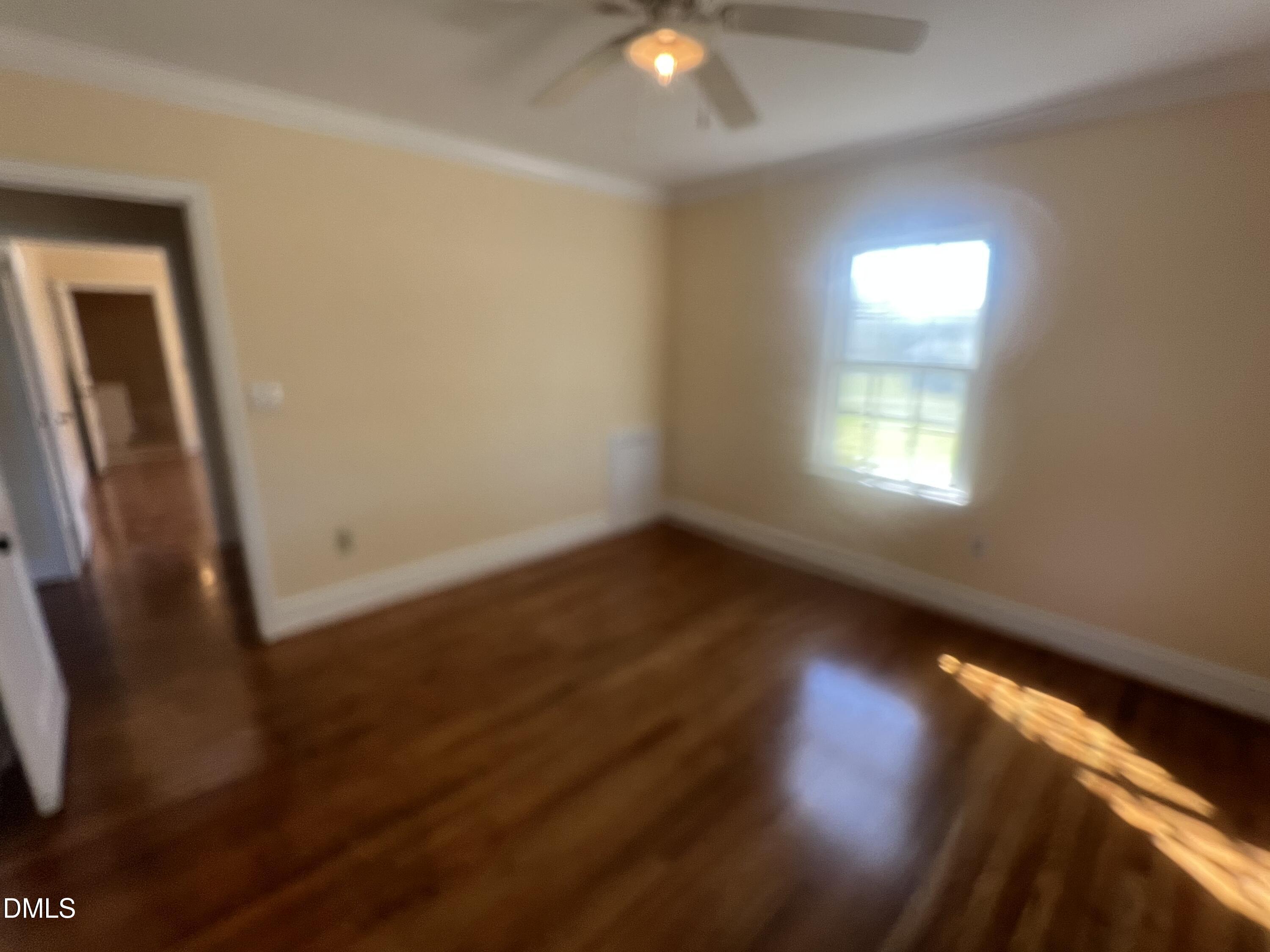 122 Bill Avery Road Coats, NC 27521 - Photo 15 of 51 an empty room with wooden floor and windows
