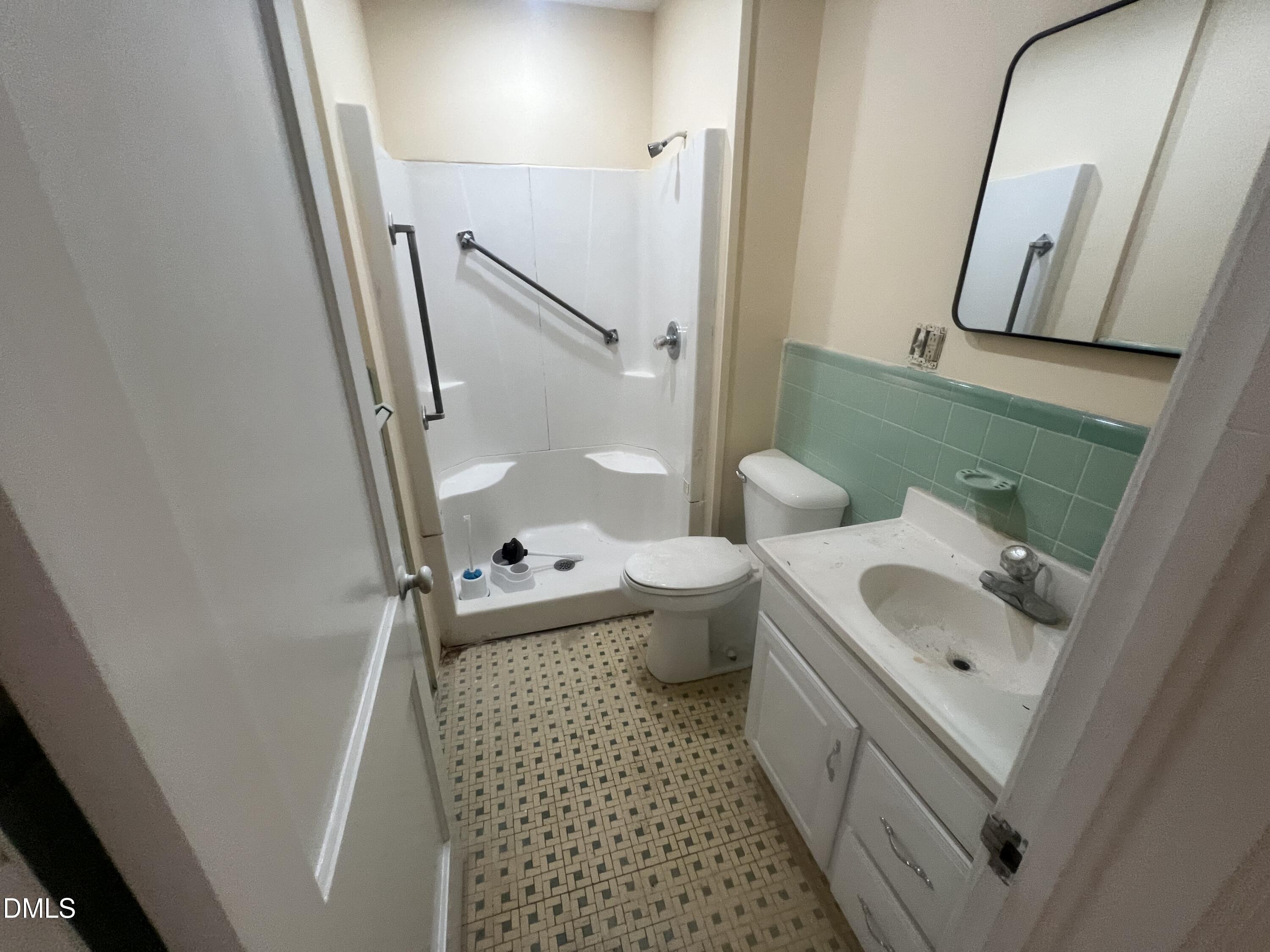 122 Bill Avery Road Coats, NC 27521 - Photo 18 of 51 a bathroom with a sink a toilet and a mirror