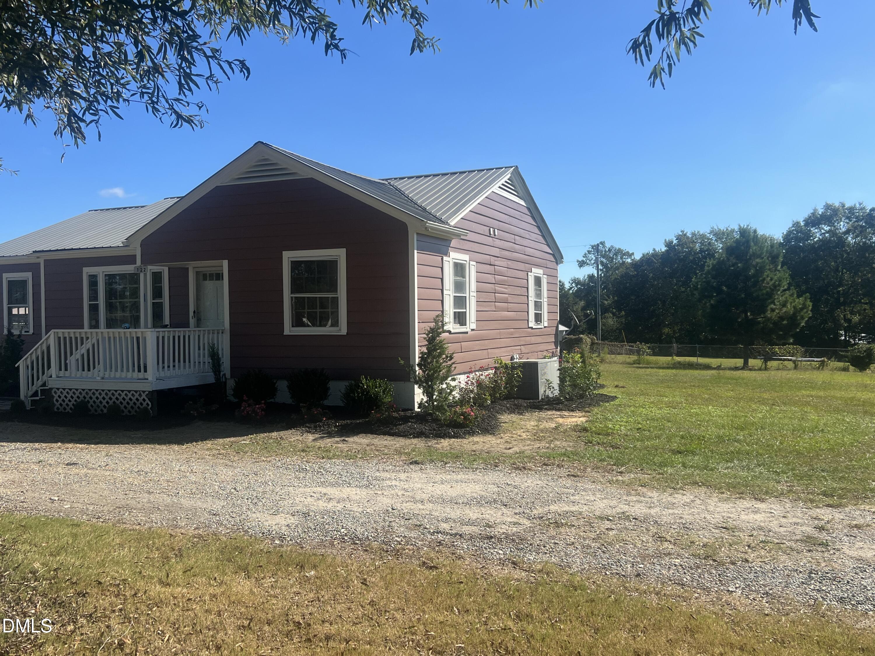 122 Bill Avery Road Coats, NC 27521 - Photo 2 of 51 a front view of a house with garden