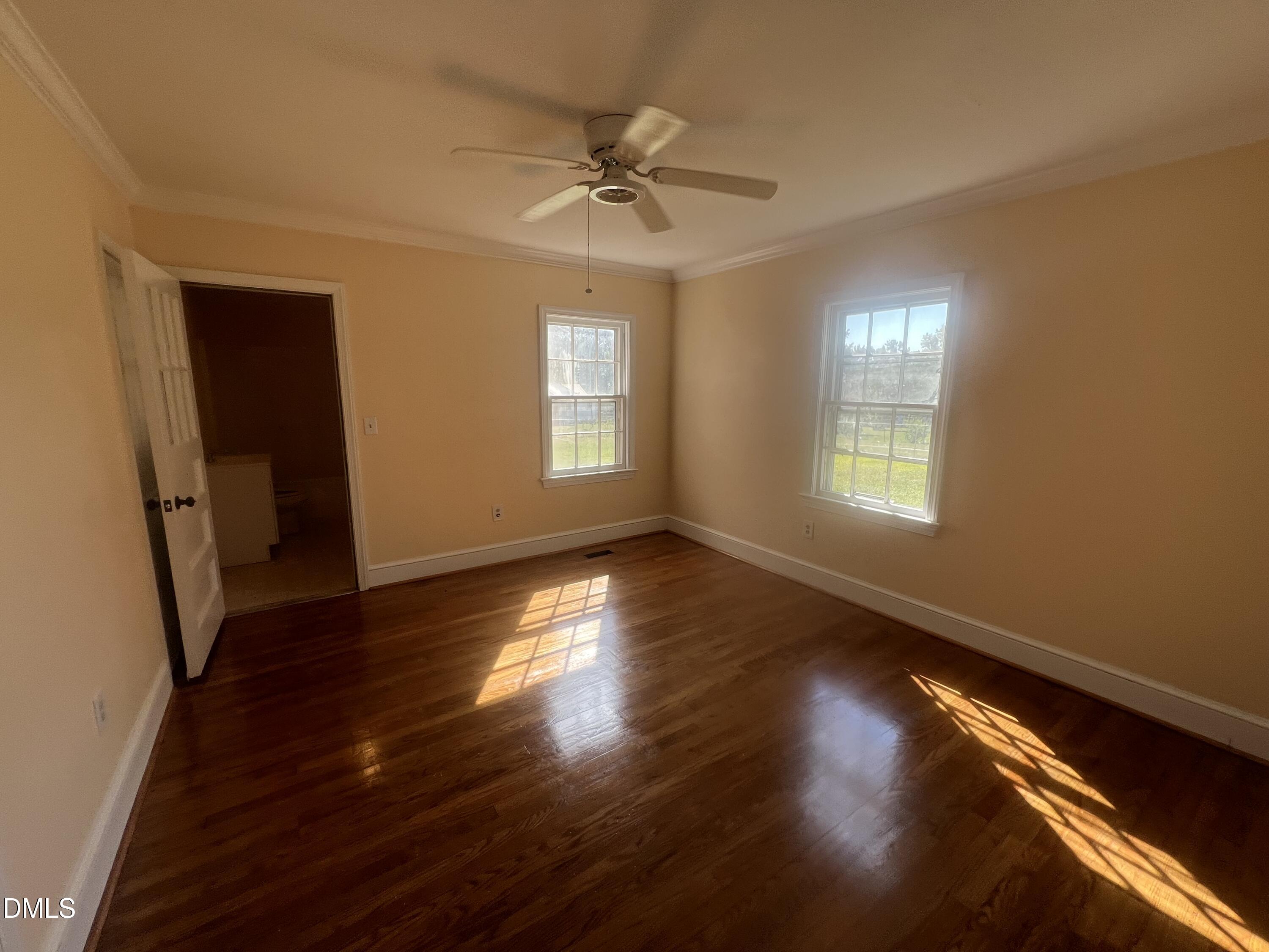 122 Bill Avery Road Coats, NC 27521 - Photo 25 of 51 a view of an empty room with wooden floor and a window