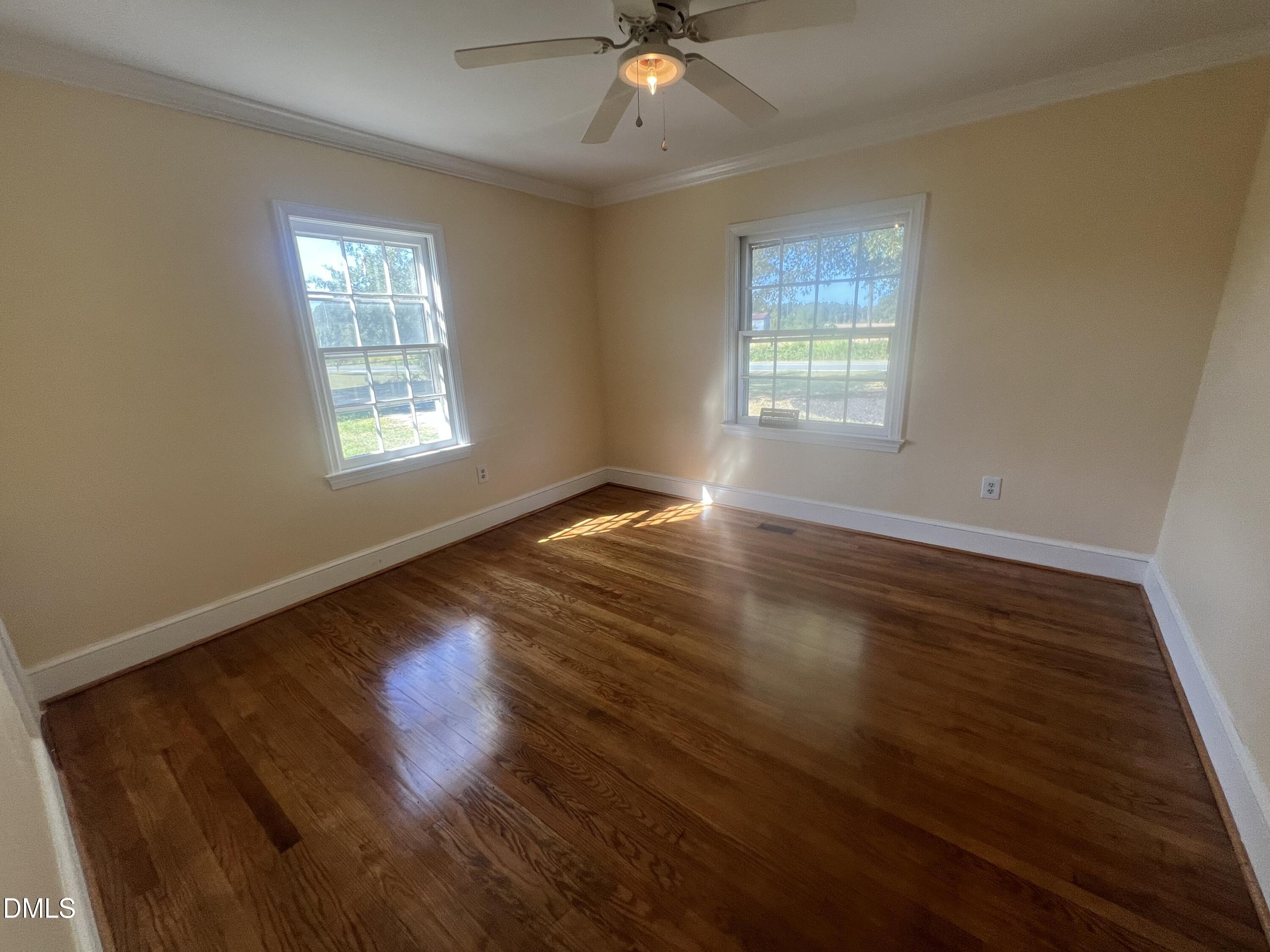 122 Bill Avery Road Coats, NC 27521 - Photo 27 of 51 a view of an empty room with wooden floor and a window