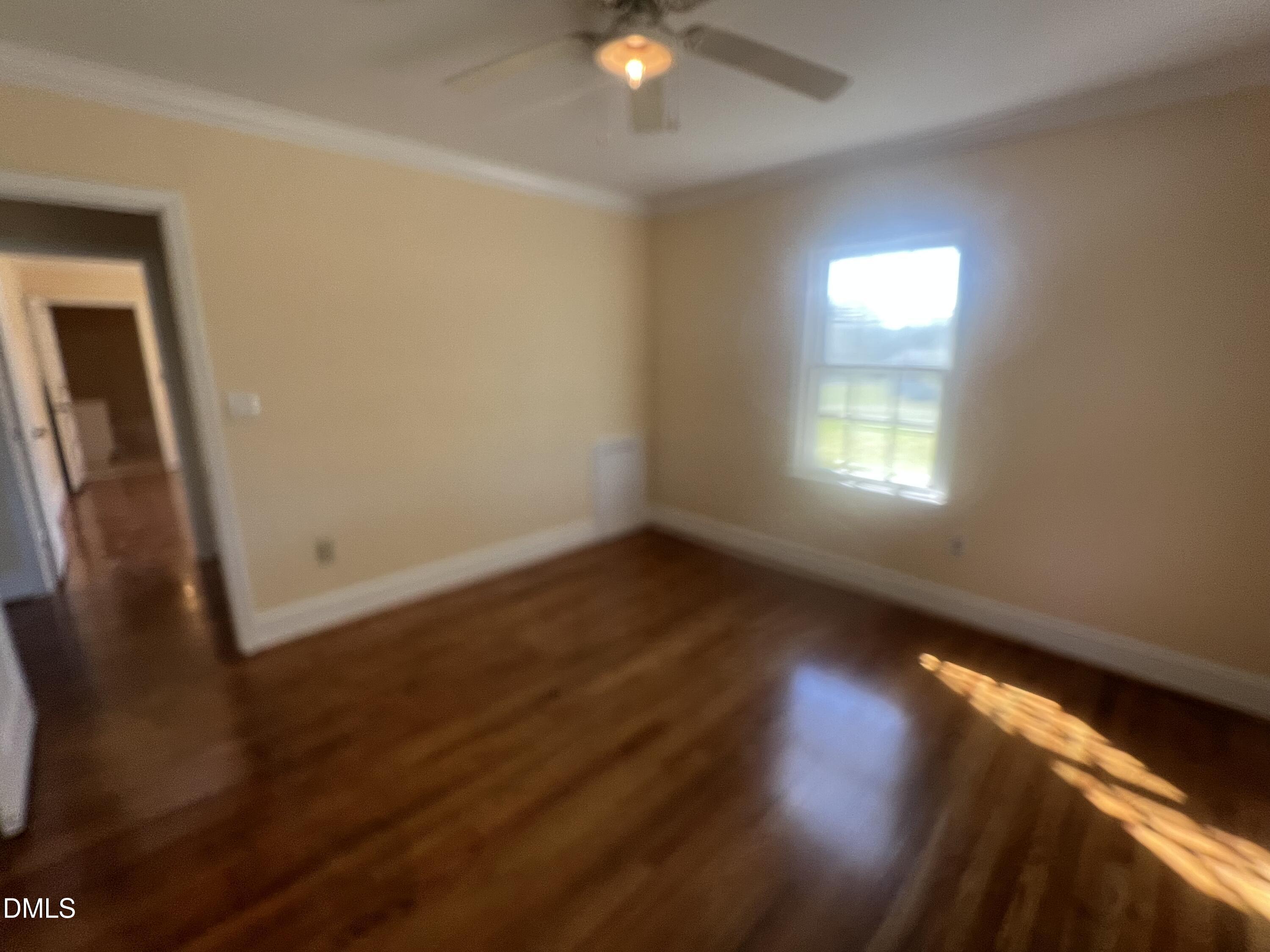 122 Bill Avery Road Coats, NC 27521 - Photo 28 of 51 a view of an empty room with wooden floor and a window