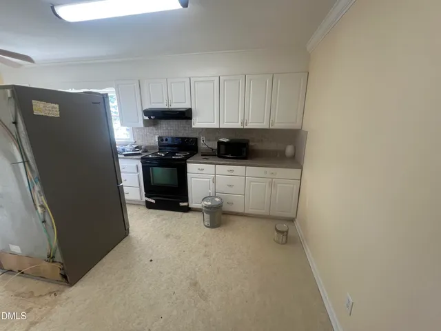 a kitchen with stainless steel appliances a refrigerator and a stove top oven