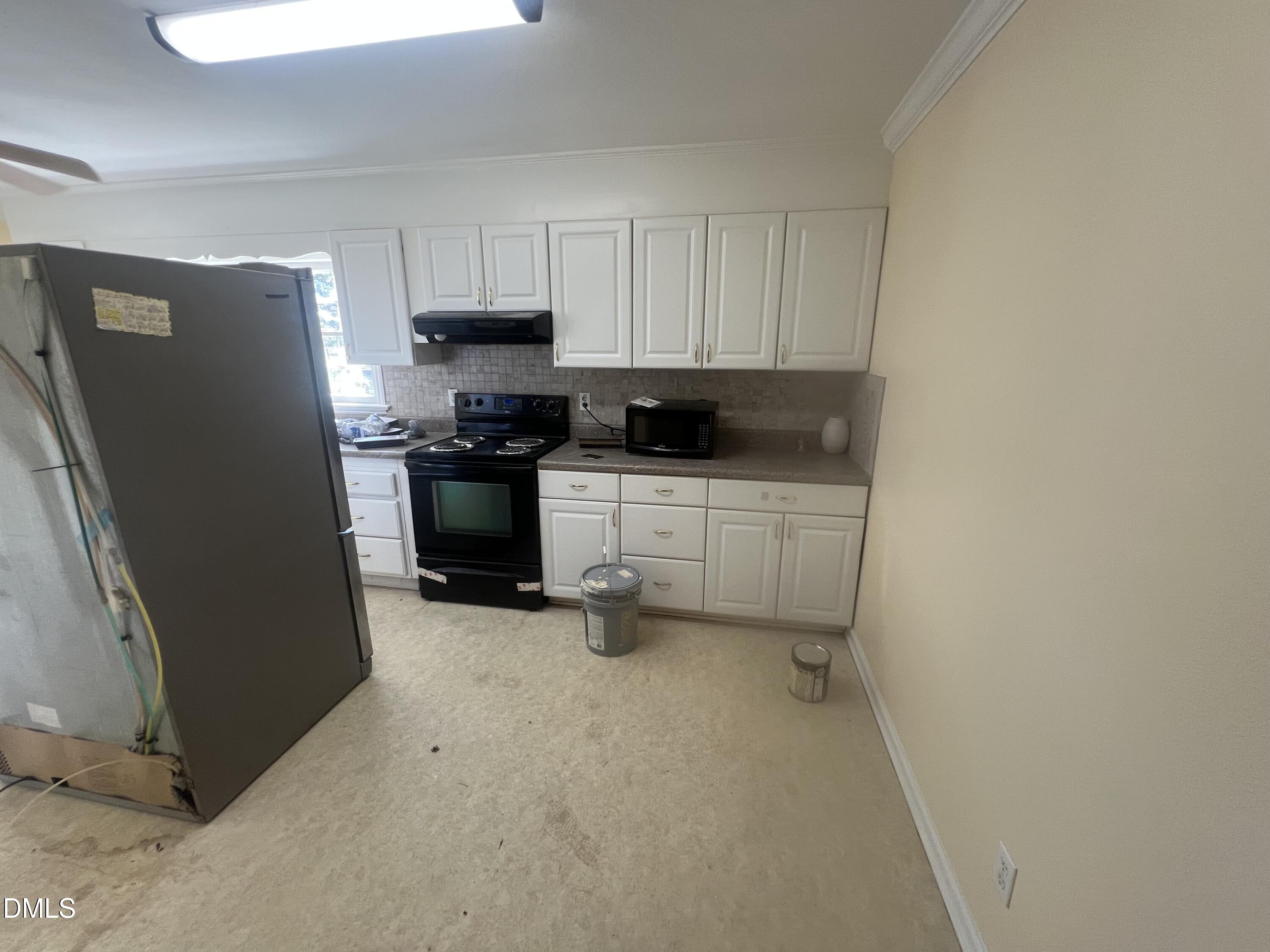 122 Bill Avery Road Coats, NC 27521 - Photo 29 of 51 a kitchen with stainless steel appliances a refrigerator and a stove top oven