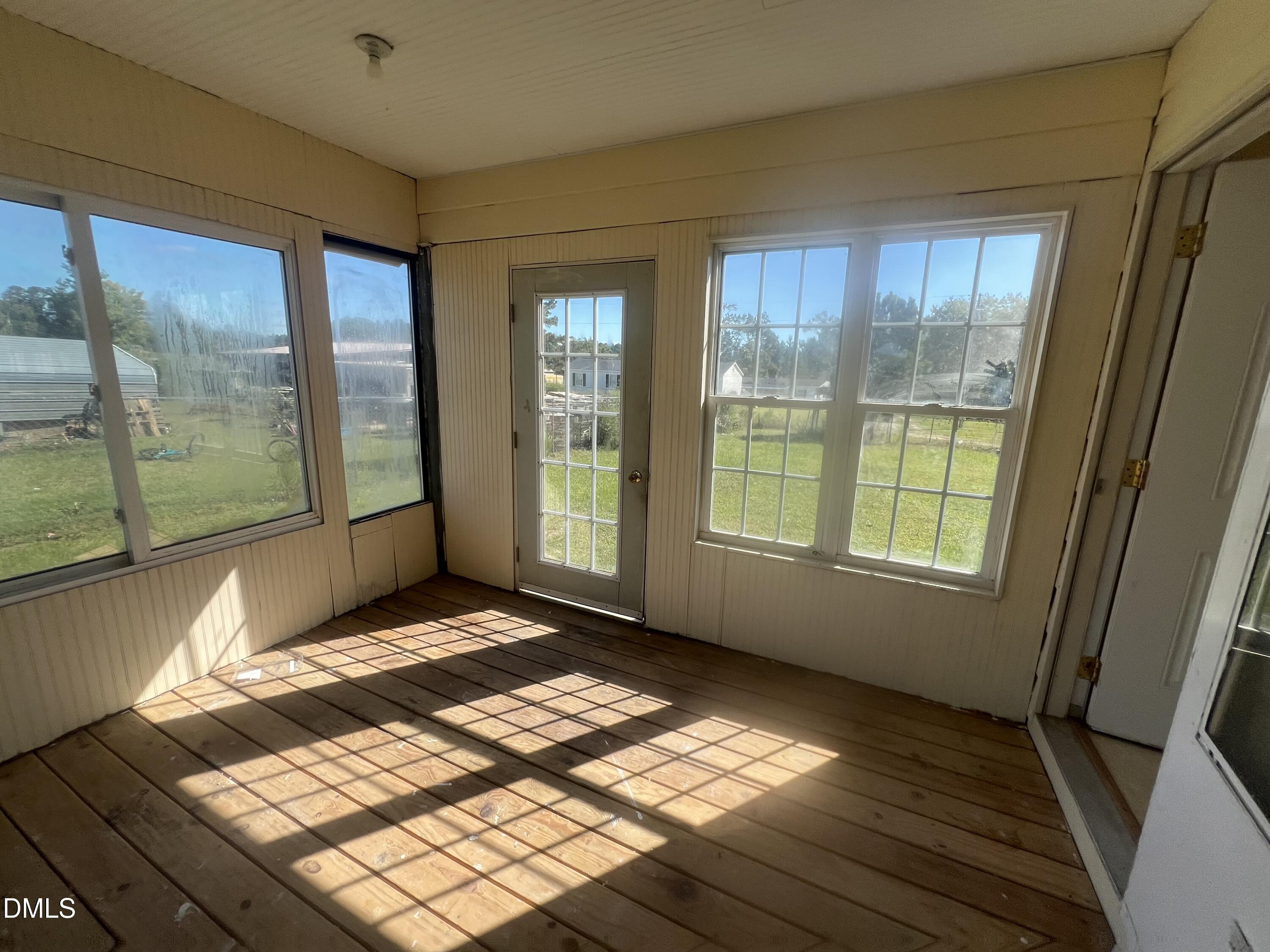 122 Bill Avery Road Coats, NC 27521 - Photo 35 of 51 a view of an empty room with wooden floor and a window