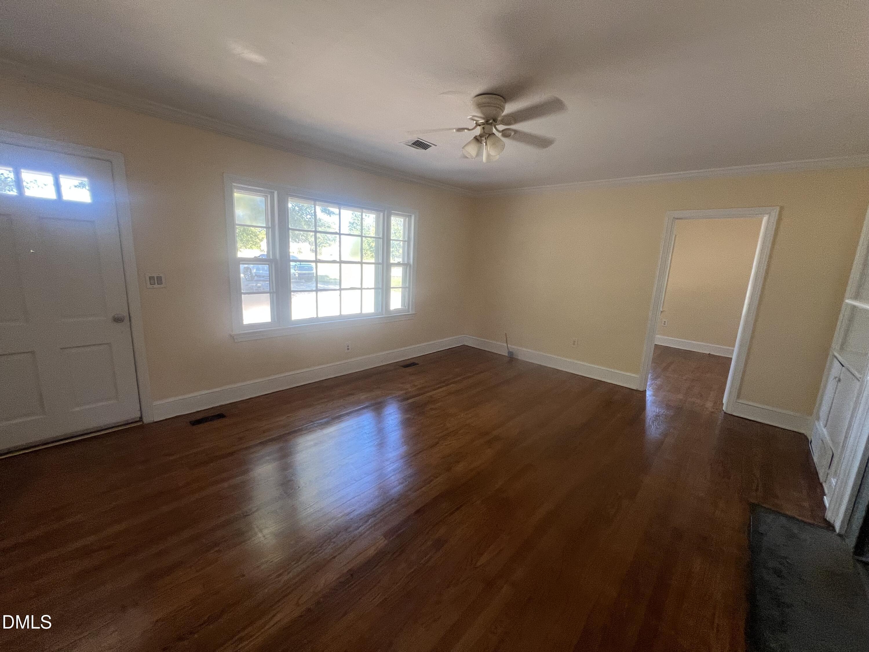 122 Bill Avery Road Coats, NC 27521 - Photo 40 of 51 a view of an empty room with wooden floor and a window